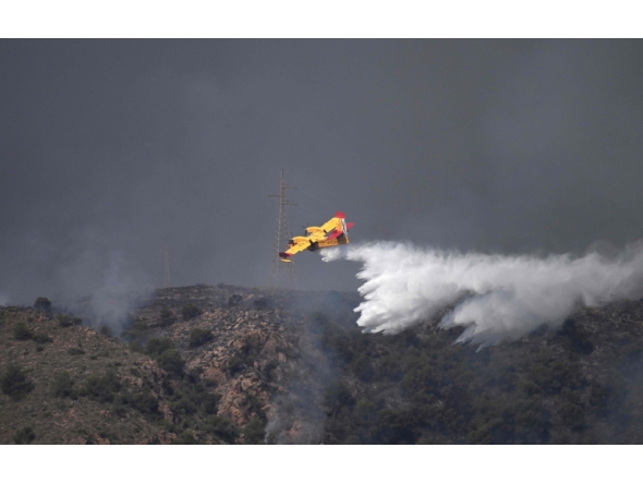 A picture taken on July 10, 2026 shows a Canadair water bombing aircraft on the site of a wildfire that killed 11 near Los Gallardos, in Almeria Province. (Photo by Jose Jordan / AFP)
