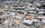 Tents and shelters are pictured next to rubble of collapsed buildings at a camp for people displaced by war in the Sheikh Radwan neighbourhood of Gaza City on July 6, 2026. Photo by OMAR AL-QATTAA / AFP