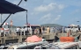 Ambulances line up on a pier to help victims of a boating accident after a tourist vessel capsized off Phu Quoc Island in southern Vietnam's An Giang Province on July 11, 2026. At least 15 people were killed when a tourist boat capsized off an island in Vietnam's south, state media reported on July 11. (Photo by AFP)