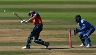 England's Jos Buttler hits a boundary as India's Sanju Samson keeps wicket during the fifth Twenty20 (T20) International cricket match between England and India at Utilita Bowl in Southampton on July 11, 2026. (Photo by JUSTIN TALLIS / AFP)