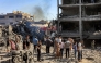 People gather by the rubble of destroyed buildings following an Israeli strike on an industrial area in Gaza City on July 12, 2026. (Photo by Omar Al-Qattaa / AFP)