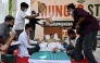 Cockroach Janta Party (CJP) founder Abhijeet Dipke (2R) reacts as doctors check activist Sonam Wangchuk vital signs during his hunger strike in New Delhi on July 15, 2026, demanding the resignation of India Education Minister Dharmendra Pradhan over alleged examination irregularities. (Photo by Arun SANKAR / AFP)
 