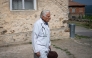 Dr. Apostolov, 90, a general practitioner, leaves his consulting room to visit a patient in the village of Skrat, in the foothills of the Belasitsa Mountains on July 15, 2026. (Photo by Nikolay Doychinov / AFP)
