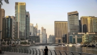 A woman walks through Dubai's Marina district on July 21, 2026. (Photo by Fadel Senna / AFP)