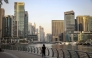 A woman walks through Dubai's Marina district on July 21, 2026. (Photo by Fadel Senna / AFP)