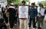 A Cockroach Janta Party (CJP) supporter holds a placard at Jantar Mantar in New Delhi on July 22, 2026. (Photo by Sajjad Hussain / AFP)