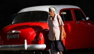 (FILES) An elderly woman walks in a street of Havana, on June 3, 2025. (Photo by YAMIL LAGE / AFP)