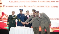Chinese Ambassador to Qatar H E Cao Xiaolin (centre) and other officials during a cake-cutting ceremony at the reception.