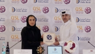  Executive Director of Sales, Marketing and Communication at QSL Hassan Rabiah Al Kuwari and Head of Marketing and Public Relations, Doha Bank, Al Anoud Khalid Al Attiyah during the partnership signing ceremony.