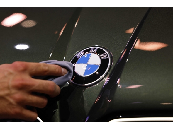 (Files) A staff member cleans the car logo of a BMW at the International Motor Show IAA on September 8, 2025, in Munich, southern Germany. (Photo by Alexandra Beier / AFP)
 