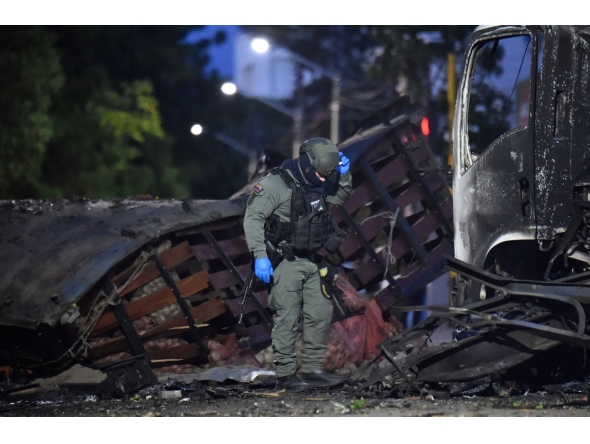 A police officer inspects the wreckage of a truck after a car bomb detonated near a police station in Cucuta, Colombia, on August 1, 2026. (Photo by Schneyder Mendoza / AFP)