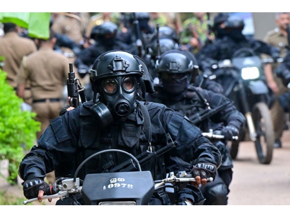Military personnel wearing anti-riot gear patrol on bikes outside the Mahara Prison complex on the outskirts of Colombo on August 2, 2026. Photo by Ishara S. KODIKARA / AFP