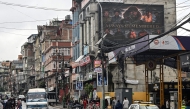 A digital billboard (top, R) displays the condolences after the death of mountaineer Nirmal Purja and his companions by an avalanche in Pakistan, in Kathmandu, on August 2, 2026. Photo by Prakash MATHEMA / AFP