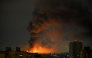 Smoke rises above residential buildings following an air attack in Kyiv on August 1, 2026. (Photo by Eugene Kotenko / AFP)
 