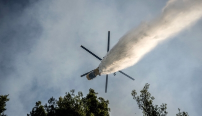 A firefighting helicopter drops water over a wildfire in the area of Porto Germeno, some 70 kilometres (45 miles) northwest of Athens in the region of Viotia, on August 2, 2026. (Photo by Angelos TZORTZINIS / AFP)