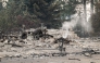 A burned motorcycle sits in the ashes of burned out residential home in the Balboa neighborhood of Spokane, Washington, on August 2, 2026. (Photo by Erick Doxey / AFP)
 