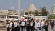 Family members march while carrying the portraits of the victims of 2020 Beirut port blast near the blast's ground zero on the sixth anniversary of the explosion, in Beirut on August 4, 2026. Photo by Anwar AMRO / AFP