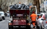 This illustration picture shows an employee of Rome's garbage collection 