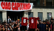 AC Milan supporters gather for the funeral of late AC Milan football player Franco Baresi outside the Sant但mbrogio Basilica in Milan on August 4, 2026. (Photo by Stefano RELLANDINI / AFP)