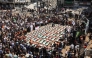 Palestinian mourners attend the funeral of members of the Abu Sharia and al-Hasayna families, whose remains were recently recovered from the rubble of residential buildings in the al-Sabra neighbourhood which were struck by Israeli bombardments in November 2023, in Gaza City on August 4, 2026. (Photo by Omar AL-QATTAA / AFP)