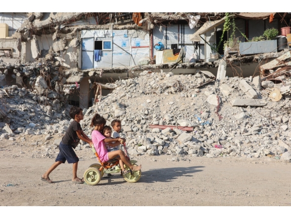 Palestinian children play near the rubble of destroyed buildings in Gaza City on August 2, 2026. Photo by OMAR AL-QATTAA / AFP