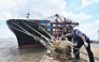 Police officers check the mooring lines of a vessel ahead of a typhoon in Beilun District of Ningbo City, east China's Zhejiang Province, (Photo by Hu Jiajie/Xinhua)