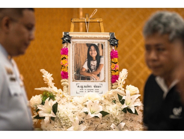 A portrait of 12-year-old school shooting victim Naphat Chaima is displayed in front of the coffin during her funeral at the Wat Lat Pla Duk Buddhist temple in Nonthaburi province, north of Thailand's capital Bangkok, on August 9, 2026. Photo by Chanakarn LAOSARAKHAM / AFP