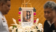 A portrait of 12-year-old school shooting victim Naphat Chaima is displayed in front of the coffin during her funeral at the Wat Lat Pla Duk Buddhist temple in Nonthaburi province, north of Thailand's capital Bangkok, on August 9, 2026. Photo by Chanakarn LAOSARAKHAM / AFP