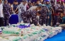 Officers from various Indonesian agencies prepare sacks containing ketamine during a press conference revealing an international narcotics smuggling case in Batam, Riau Islands, on August 9, 2026. Photo by ANDARU AK / AFP
