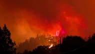 FILE PHOTO: This handout photo taken on August 7, 2026, and released on August 8 by the BC Wildlife Service shows the Bald Range wildfire near Summerland in Canada's western British Columbia province.(Photo by Handout / BC Wildfire Service / AFP) / 