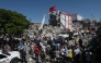 People look for survivors amid the rubble of a collapsed building after an earthquake in Cali, Colombia on August 10, 2026. (Photo by JOAQUIN SARMIENTO / AFP)
