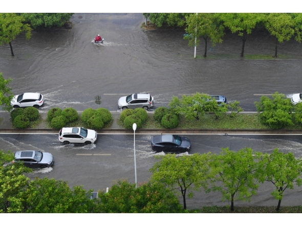 Vehicles drive through a waterlogged street in Wuxi, east China's Jiangsu Province, Aug. 10, 2026. (Photo by Huan Yueliang/Xinhua)