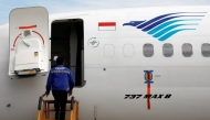 Reuters file photo for representation showing a technician boarding a parked Garuda Indonesia airplane.