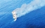 This screen grab picture from a handout video taken and released on August 12, 2026 by the Indonesian National Search and Rescue Agency (Basarnas) shows the Putri Yasmin ferry, which serves the Padangbai-Bali- to Lembar-West Nusa Tenggara route, on fire in the waters of Bali. (Photo by Handout (Green Road Waste Management ) / Indonesian National Search and Rescue Agency (BASARNAS) / AFP)