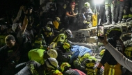 Firefighters and rescue teams carry survivor Daniela Andrea Largo Sanchez out of the rubble of a collapsed building after an earthquake in Pereira, Colombia on August 11, 2026.  (Photo by David SALAZAR / AFP)
