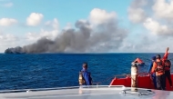 This screen grab picture from a handout video taken and released on August 12, 2026 by the Indonesian National Search and Rescue Agency (Basarnas) shows the Putri Yasmin ferry, which serves the Padangbai-Bali- to Lembar-West Nusa Tenggara route, on fire in the waters of Bali. (Photo by Handout (Green Road Waste Management )