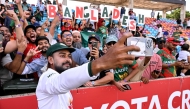 Bangladesh player Mehidy Hasan Miraz poses with fans after victory against Australia on the fourth day of the first cricket Test match between Australia and Bangladesh at Marrara Stadium in Darwin on August 16, 2026. (Photo by William WEST / AFP)