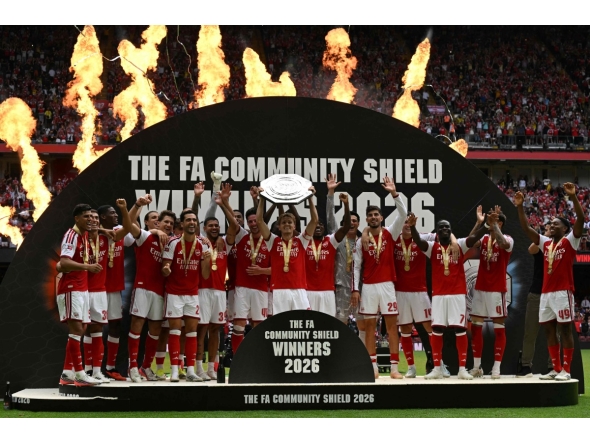 Arsenal's Norwegian midfielder #08 Martin Odegaard lifts the trophy as Arsenal's players celebrate their victory after the English FA Community Shield football match between Arsenal and Manchester City at The Principality Stadium, in Cardiff, south Wales on August 16, 2026. Arsenal won the game 3-0. (Photo by Glyn KIRK / AFP)