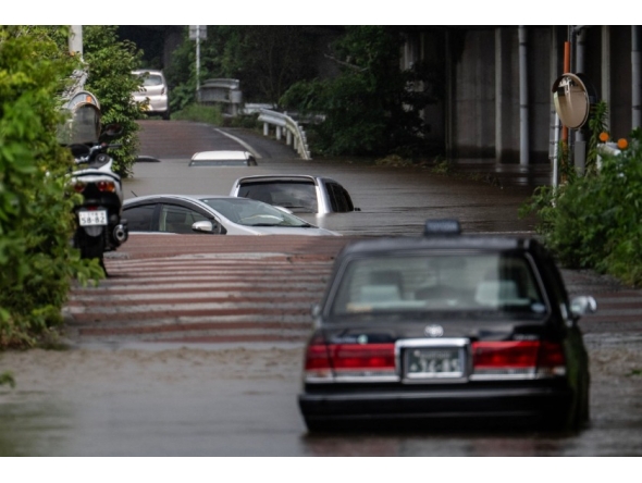 Abandoned cars partially submerged on a flooded road in Chiba prefecture. AFP file photo.
