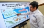 This picture taken on August 6, 2026 shows I Putu Santikayasa, hydroclimatology lecturer at IPB University, explaining the impact of El Nino in Indonesia, in Bogor, West Java. Indonesia believes cloud seeding can help it tackle a wildfire season that experts say is on track to be among the worst in years, driven by a strong El Nino. (Photo by BAY ISMOYO / AFP)