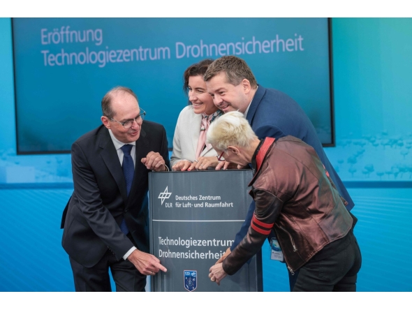 (L-R) German Interior Minister Alexander Dobrindt, German Minister for Research, Technology and Aerospace Dorothee Baer, Saxony-Anhalt's State Premier Sven Schulze and the Chairwoman of the DLR Executive Board Anke Kaysser-Pyzalla take part in the opening of the new Drone Safety Technology Center at the Cochstedt site of the German Aerospace Center (DLR), eastern Germany on August 18, 2026. (Photo by Ronny HARTMANN / AFP)