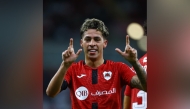 Al Rayyan's Gabriel Pereira celebrates after scoring a goal. RIGHT: Al Rayyan's Roger Guedes (right) in action during a match against Lusail at Ahmad Bin Ali Stadium yesterday. 