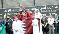 Qatar Table Tennis Association officials pose for photos with victorious Team Qatar players. 