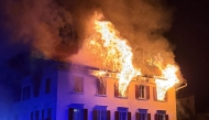 This handout photograph taken and released on August 21, 2026 by the Cantonal Police of Graubunden (Kantonspolizei Graubunden) shows a fire that broke out in a building in the small town of Thusis, eastern Switzerland. Photo by Handout / Kantonspolizei Graubünden / AFP