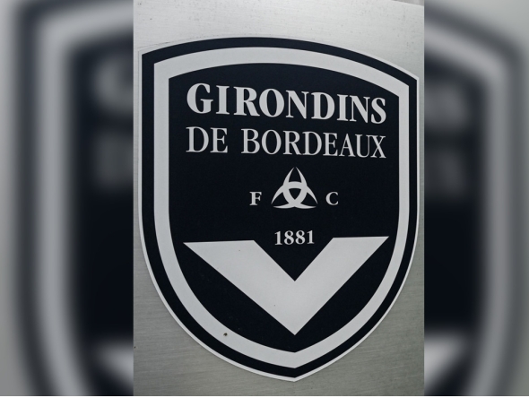 (FILES) This general view taken on May 19, 2022, shows a sign with a logo in front of the chateau of FC Girondins de Bordeaux at the club's training ground in Le Haillan, near Bordeaux, south-western France. (Photo by Philippe LOPEZ / AFP)