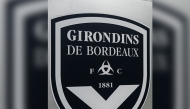 (FILES) This general view taken on May 19, 2022, shows a sign with a logo in front of the chateau of FC Girondins de Bordeaux at the club's training ground in Le Haillan, near Bordeaux, south-western France. (Photo by Philippe LOPEZ / AFP)