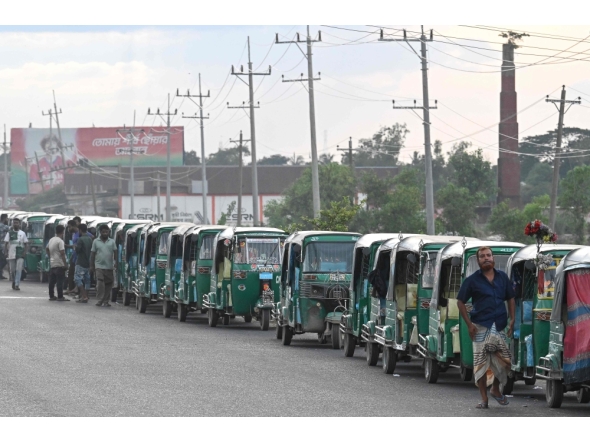This photograph taken on August 12, 2026 shows CNG-powered autorickshaws waiting for long hours to refuel in Bangladesh's Brahmanbaria district. (Photo by Salahuddin Ahmed / AFP)