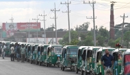 This photograph taken on August 12, 2026 shows CNG-powered autorickshaws waiting for long hours to refuel in Bangladesh's Brahmanbaria district. (Photo by Salahuddin Ahmed / AFP)