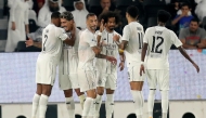 Al Sadd players celebrate during their match against Al Ahli.