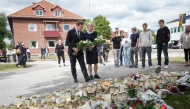 Swedish Prime Minister Ulf Kristersson and Social Democratic Party leader Magdalena Andersson visit the makeshift memorial outside a school in Fagersta, central Sweden, on August 22, 2026, a day after a 17-year-old girl was killed and three other people were injured in a sword attack at the school. Photo by Magnus LEJHALL / TT NEWS AGENCY / AFP
